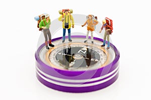 Miniature people: Group of backpacker standing on compass ,using as background travel, business concept.