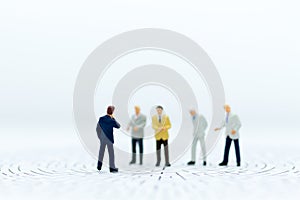 Miniature people: Group of businessmen work with team. Image use for background choice of the best suited employee