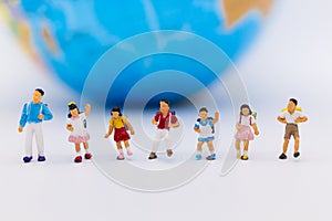 Miniature people : Group children standing with world map. Image use for study international, back to school concept