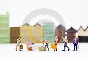 Miniature people: Group people carry a bag suitcase. Image use for business concept