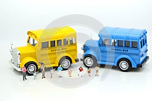 Miniature people : A group of young children getting on the schoolbus,schoolbus transportation education