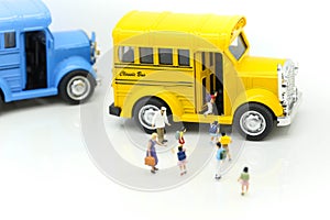 Miniature people : A group of young children getting on the schoolbus,schoolbus transportation education