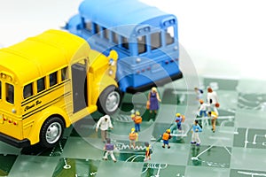 Miniature people : A group of young children getting on the schoolbus,schoolbus transportation education