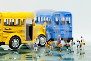 Miniature people : A group of young children getting on the schoolbus,schoolbus transportation education