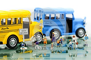 Miniature people : A group of young children getting on the schoolbus,schoolbus transportation education