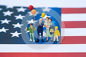 miniature people, happy american family holding balloon with Uni