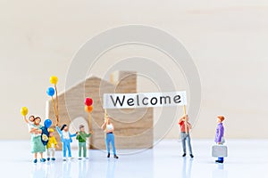 Miniature people holding Welcome signs at front of the home