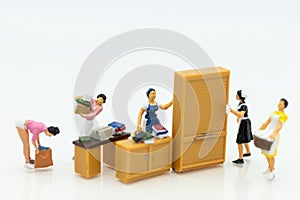 Miniature people : Housewives hire laundry - ironing, profitable business. Image use for housework, business concept photo