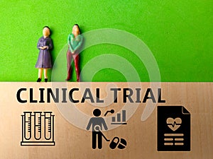 Miniature people and icon with text CLINICAL TRIAL