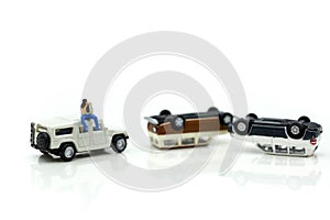 Miniature people : Insurance Agent examine Damaged Car and filing Report Claim Form after accident.