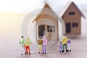 Miniature people looking for house