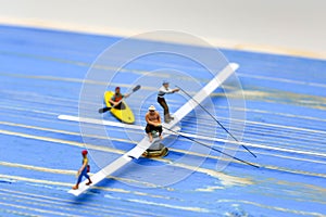 Miniature people : man fishing on a lake from the boat