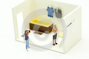Miniature people : man is hiding behind bathroom Spying. Voyeur