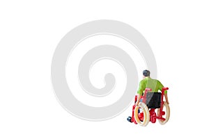 Miniature people Man in wheelchair isolated with clipping path