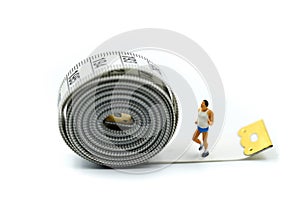 Miniature people : marathon runners with measuring tape ,jogging and running,Active and healthy lifestyle concept