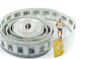 Miniature people : marathon runners with measuring tape ,jogging and running,Active and healthy lifestyle concept