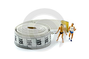 Miniature people : marathon runners with measuring tape ,jogging and running,Active and healthy lifestyle concept