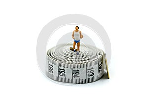 Miniature people : marathon runners with measuring tape ,jogging and running,Active and healthy lifestyle concept