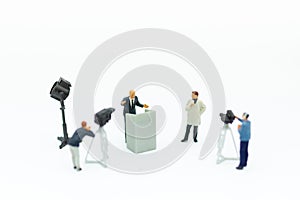 Miniature people: Moderator are interviewing businessman with camera and video capture. Image use for Entertainment Industry