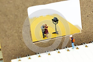 Miniature people: Moderator are interviewing guests with camera and video capture. Image use for Entertainment Industry