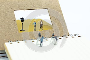 Miniature people: Moderator are interviewing guests with camera and video capture. Image use for Entertainment Industry