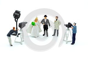 Miniature people: Moderator are interviewing love couple with camera and video capture. Image use for Entertainment Industry