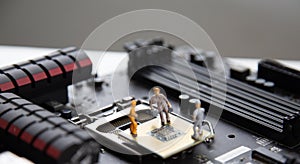 Miniature people Motherboard and  CPU repair, Concept: working in technical teams