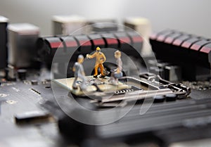 Miniature people Motherboard and  CPU repair, Concept: working in technical teams