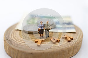 Miniature people, Old couple figure sitting on top of stack coins using as background retirement planning, Life insurance concept.