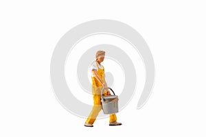 Miniature people, Painter holding paint bucket on white background with clipping path