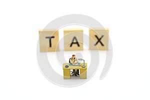 Miniature people Pay queue Annual income TAX for the year on calculator. using as background business concept and finance