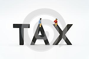 Miniature people Pay queue Annual income TAX for the year on calculator. using as background business concept and finance