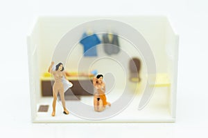 Miniature people : personal wearing a dress in the toilet, daily routine, personal errands in the bathroom photo