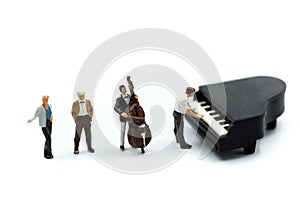 Miniature people : pianist playing piano and Violinist Man,playing musical instrument concept