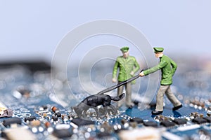 Miniature people Police And Detective are working on a computer mainboard