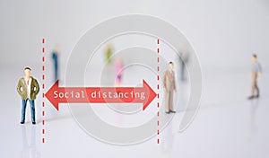 Miniature people with red arrow represent social distance of coronavirus or covid-19 issue. Social distancing concept photo