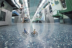 Miniature people riding bicycles in the metro.