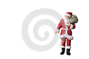 Miniature people Santa Claus carrying bag
