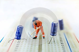 Miniature people searching or checking for bugs and issue on microchip, mainboard of computer. Vulnerability search and security