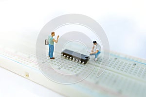 Miniature people searching or checking for bugs and issue on microchip, mainboard of computer. Vulnerability search and security