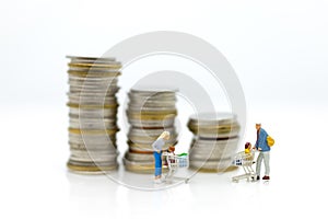 Miniature people, Shopper with children sitting on cart and stand on the stack of coins, spending money for supermarket .