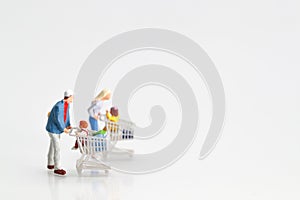 Miniature people: shopper walking on white background as payment and purchase online e-commerce and shopping concept