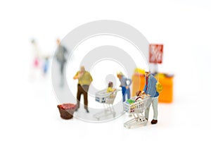 Miniature people : Shoppers with shopping cart . Image use for retail business concept