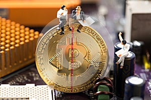 Miniature people sitting on bitcoin , halving concept