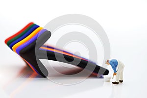 Miniature people standing whit arrow pathway choice. Concepts of problem solving, challenge and Unexpected solutions