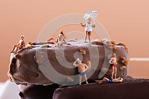 Miniature people in swimsuit on an ice cream bar photo