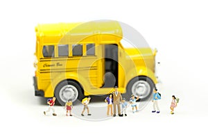 Miniature people : teacher and student with colorful drawing tools and stationary of school bus,education concept
