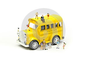 Miniature people : teacher and student with colorful drawing tools and stationary of school bus,education concept
