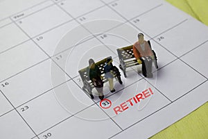 Miniature people thingking about planning for retirement target or quit they job. Isolated calendar background