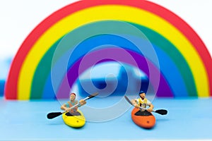 Miniature people : Tourist ride Kayaking along the rainbow. Image use for travel concept